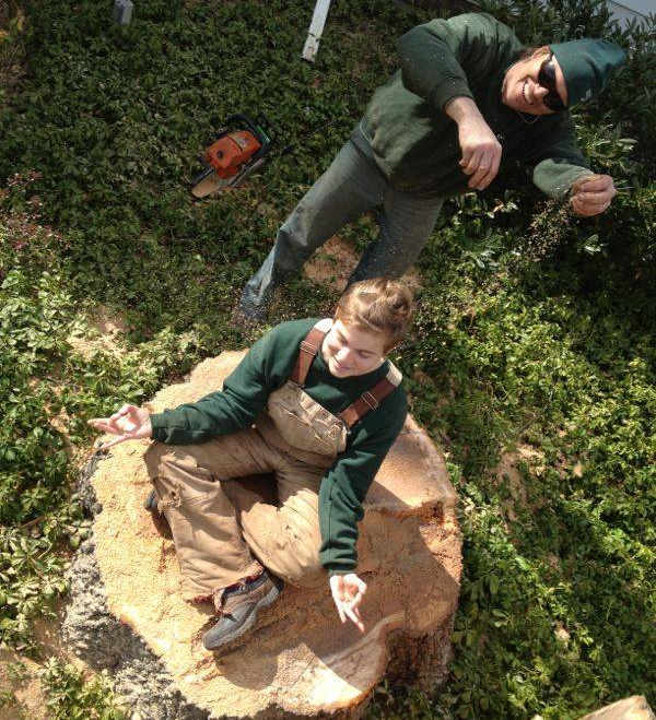 Miklos and his daughter Jessica sittong on tree stump